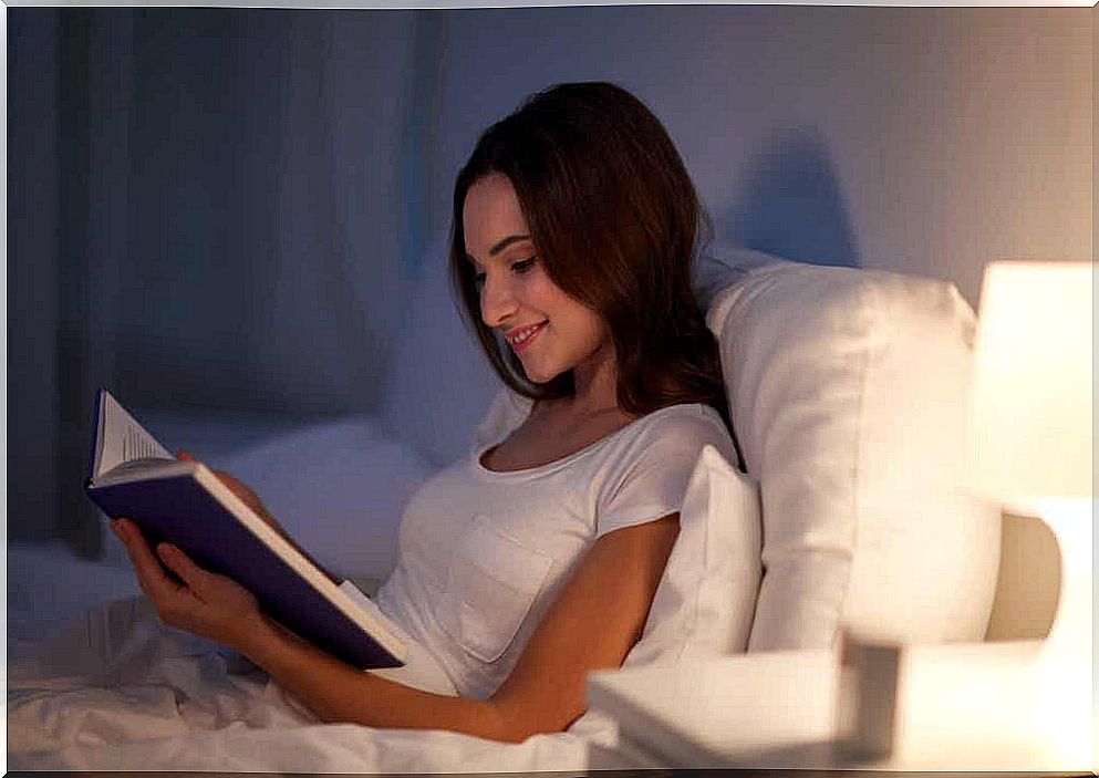 Woman reading in bed. 