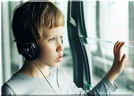 A young boy listening to music with headphones. 