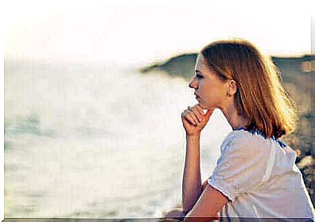 A woman facing the sea. 